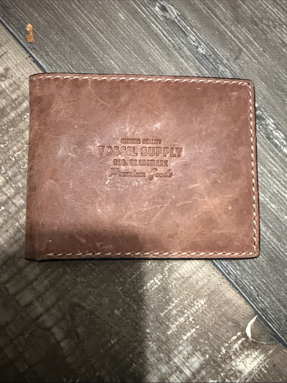 Fossil Brown Leather Bifold Wallet with Embossed Fossil Supply Logo
